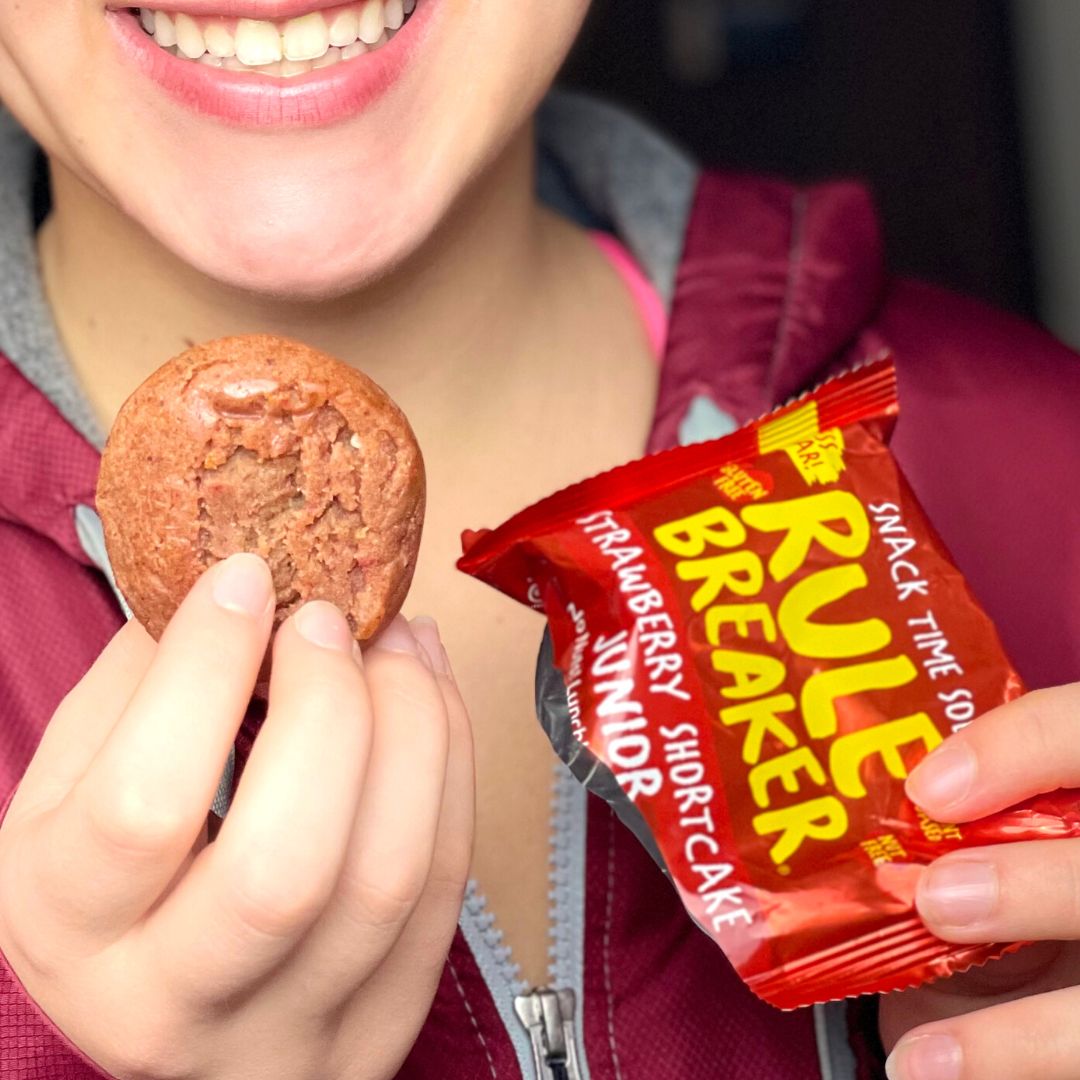 Girl holding Rule Breaker Snacks Junior