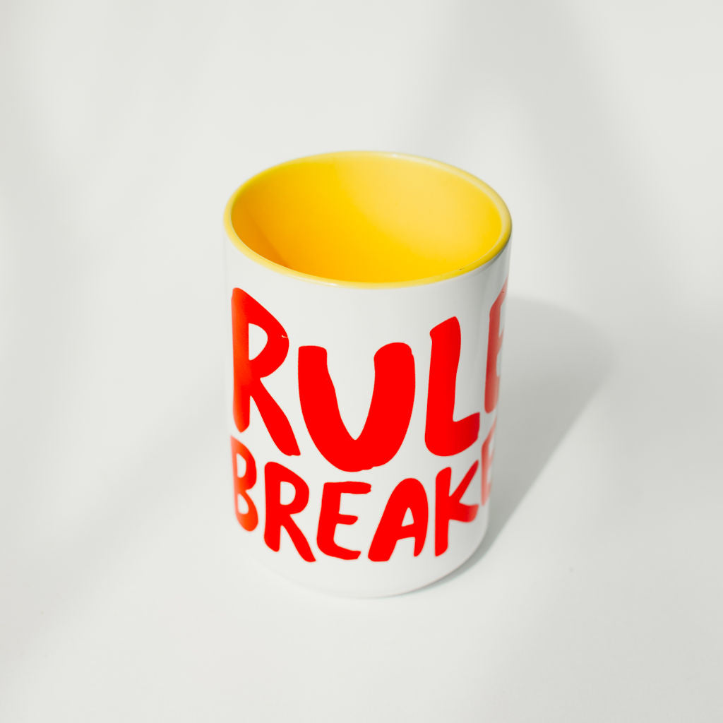 Mug with Rule Breaker logo and yellow inside