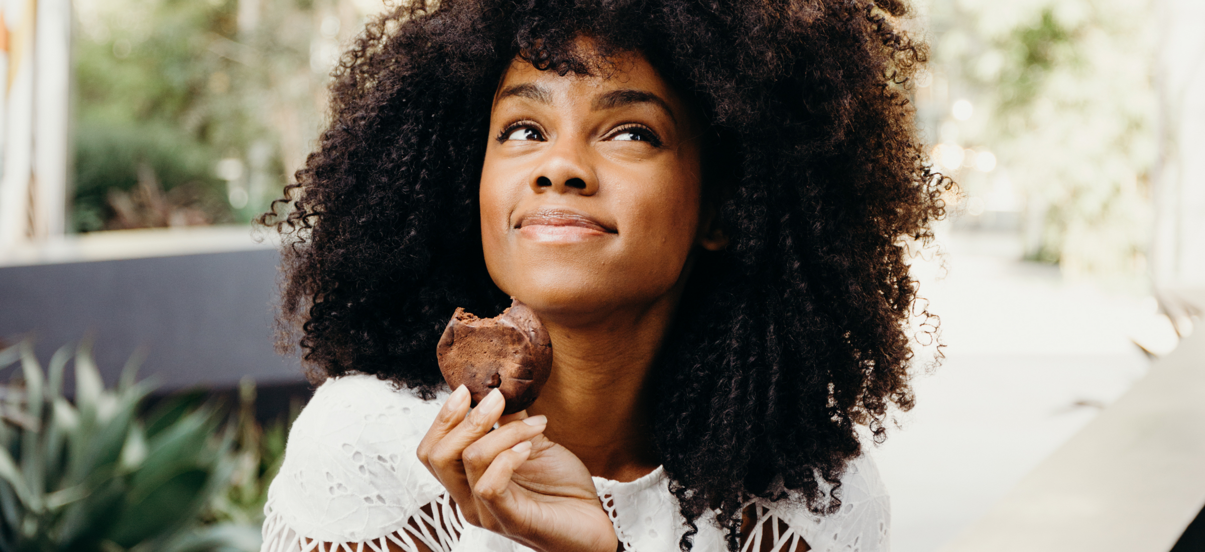 Woman enjoying Rule Breaker Snacks vegan gluten free allergen free Brownies