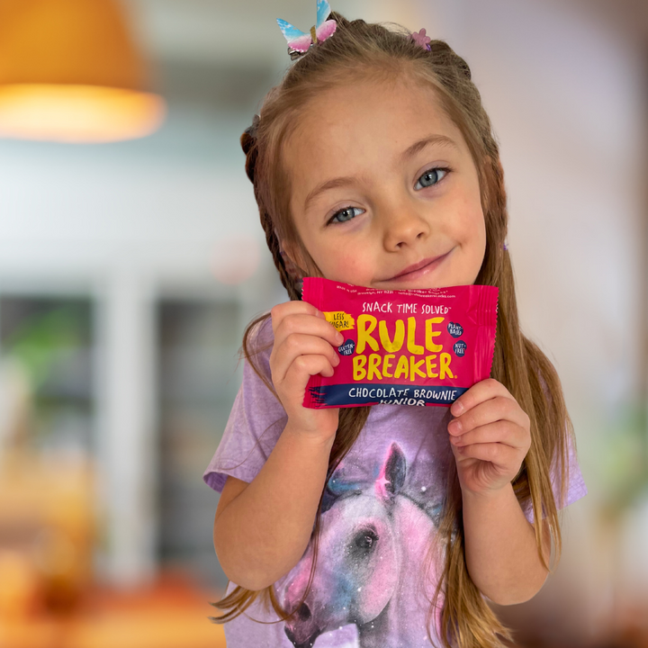 Girl holding Rule Breaker Snacks Brownie Junior