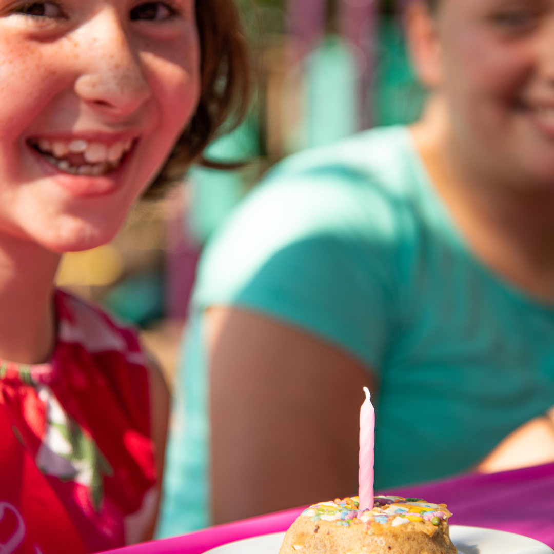 Girl smiling with Rule Breaker Birthday Cake