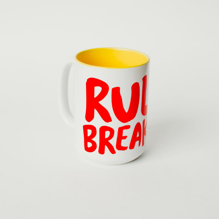 Mug with Rule Breaker logo and yellow inside