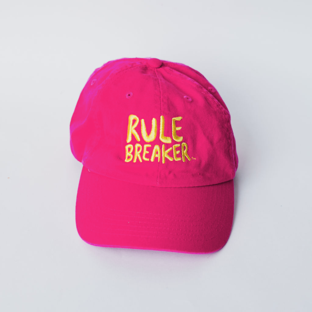 Pink hat with yellow rule breaker logo