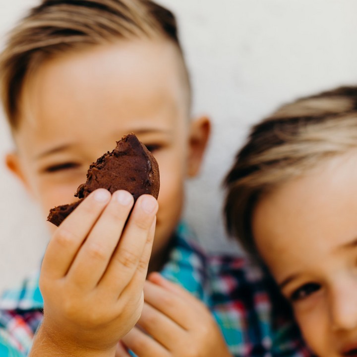 Child holding up a cookie