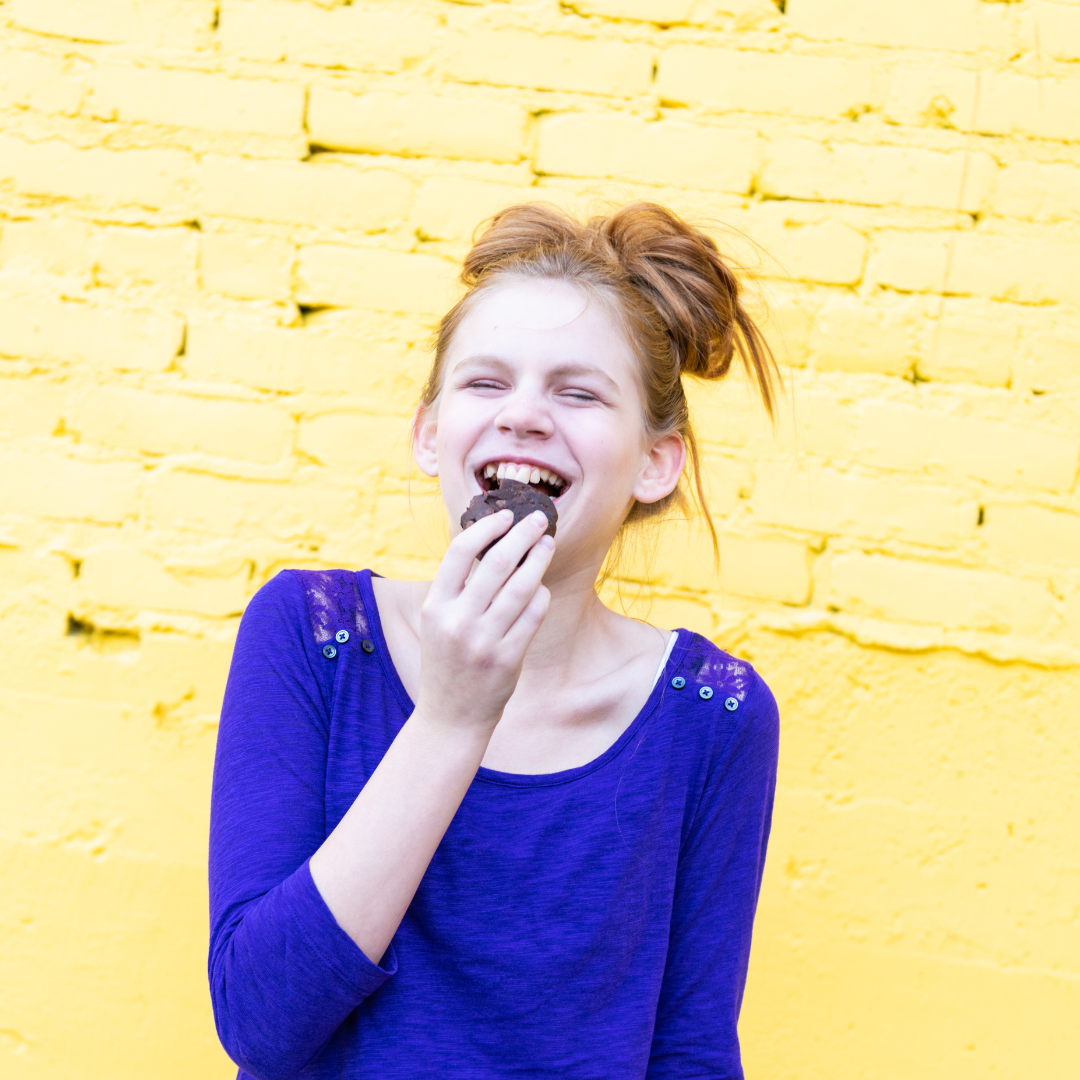 Little girl eating brownie