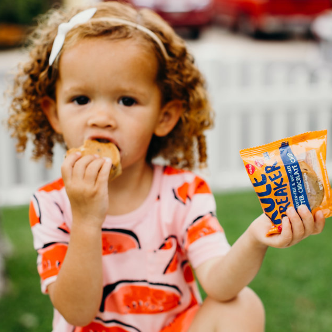 Small girl eating Rule Breaker Snacks P'nutter Chocolate Chip blondie